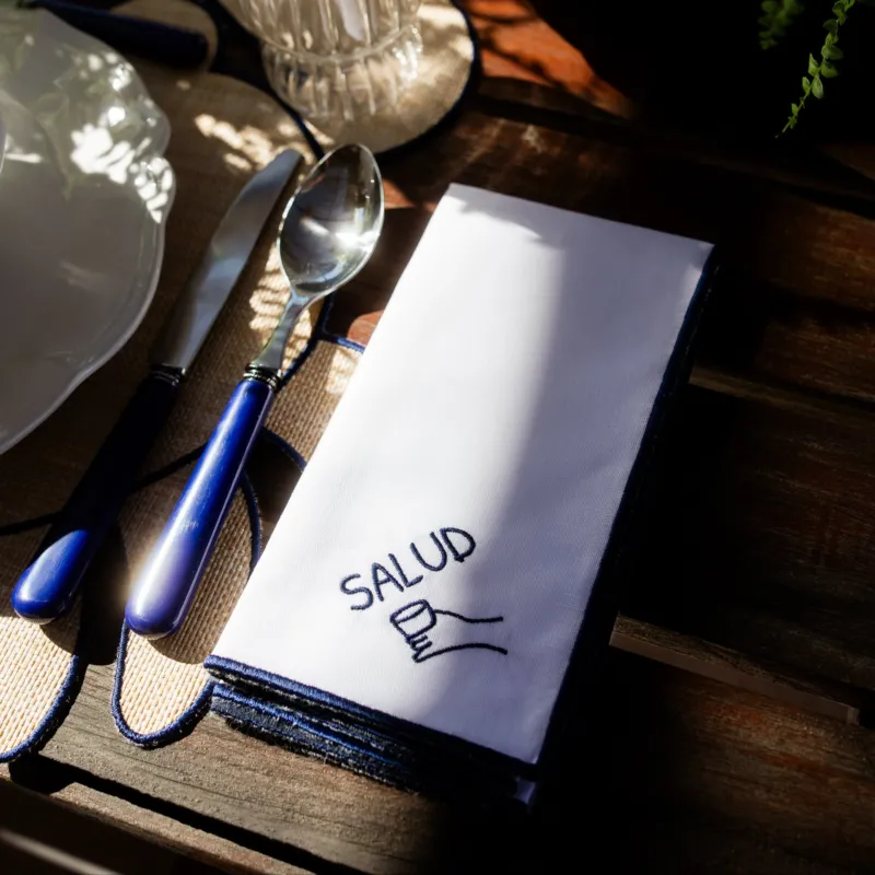 White Napkin with Blue Rolled Edge, Salud